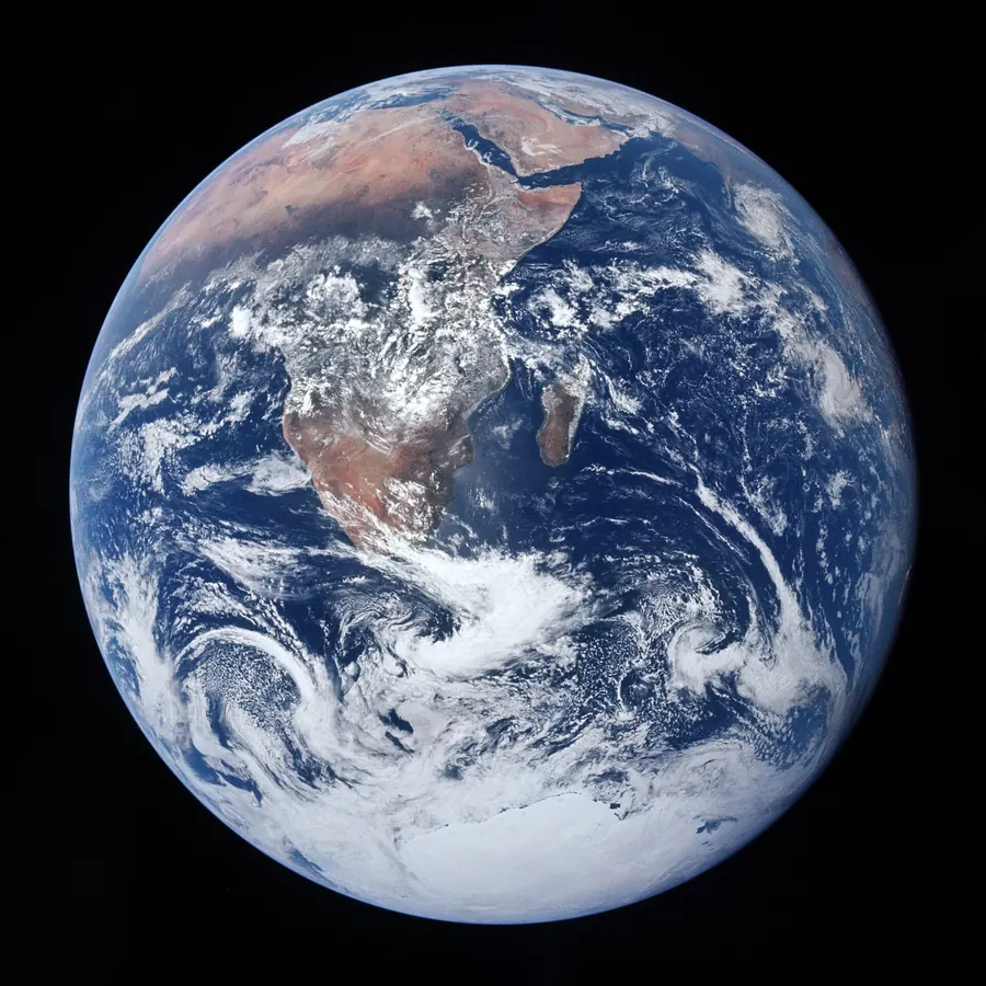 The whole Earth seen from space, blue oceans and white clouds against black.